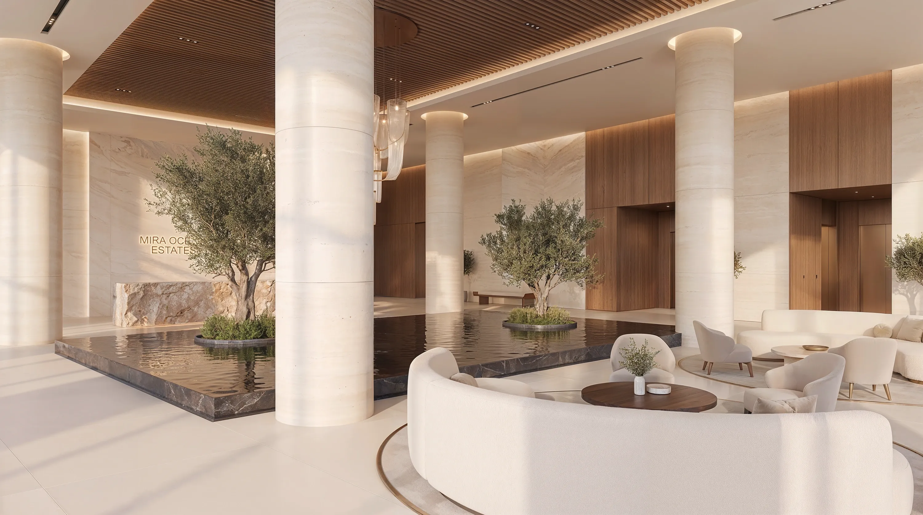 The hotel lobby lounge at Mira Ocean Estates, with travertine columns and a water feature